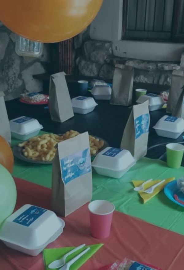 Kids’ party table with snacks, balloons, and colorful decorations at The Plot.